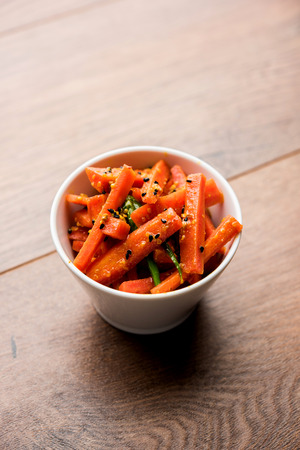 Carrot Pickle / Gajar ka Achar or Loncha in hindi. Served in a bowl over moody background. Selective focusの写真素材