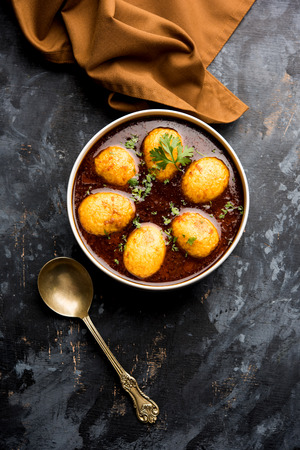 Fried egg curry or anda masala served in a bowl. selective focusの写真素材