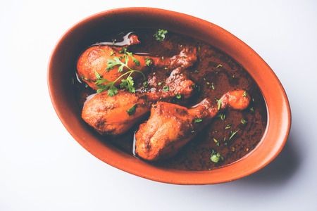 Chicken leg / drumstick curry or Murg Tangri/tangdi masala. Served in a bowl over moody background. Selective focusの写真素材