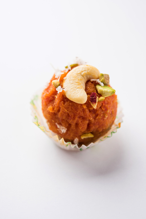Carrot Halwa Laddu or sweet balls,  served in a plate with dry fruits toppings. selective focusの写真素材
