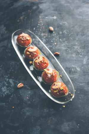 Carrot Halwa Laddu or sweet balls,  served in a plate with dry fruits toppings. selective focusの写真素材