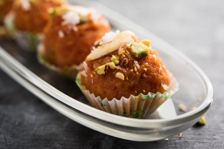 Carrot Halwa Laddu or sweet balls,  served in a plate with dry fruits toppings. selective focusの写真素材