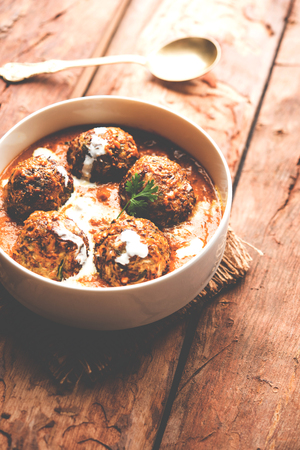 Malai Kofta is a Mughlai Speciality dish served in a bowl or pan over moody background. selective focusの写真素材