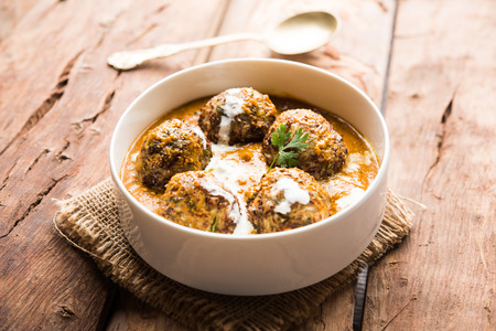 Malai Kofta is a Mughlai Speciality dish served in a bowl or pan over moody background. selective focusの写真素材