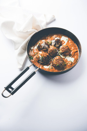 Malai Kofta is a Mughlai Speciality dish served in a bowl or pan over moody background. selective focusの写真素材