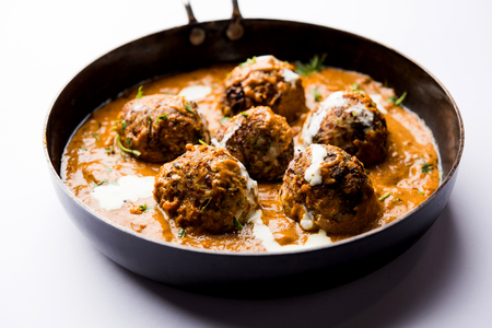 Malai Kofta is a Mughlai Speciality dish served in a bowl or pan over moody background. selective focusの写真素材