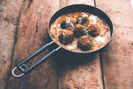 Malai Kofta is a Mughlai Speciality dish served in a bowl or pan over moody background. selective focusの写真素材