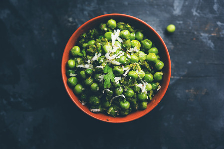 Green peas dry recipe or matar ki sookhi sabji, served in a serving pan or terracotta bowl. Selective focusの写真素材