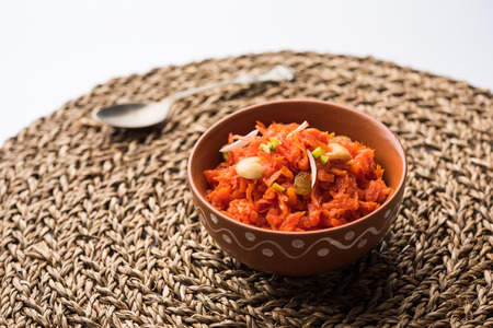 Gajar ka halwa is a carrot-based sweet dessert pudding from India. Garnished with Cashew/almond nuts. served in a bowl.の写真素材