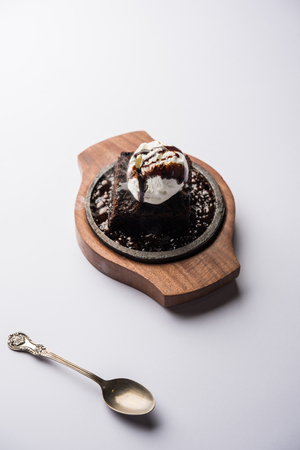 sizzling chocolate brownie is a sweet dish made using scoop of ice-cream on top served with a generous pouring of melted chocolate. server hot. selective focusの写真素材
