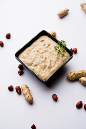 Healthy Peanut chutney made using Groundnut / Shengdana or mungfali. served in a small bowl with raw whole. Selective focusの写真素材