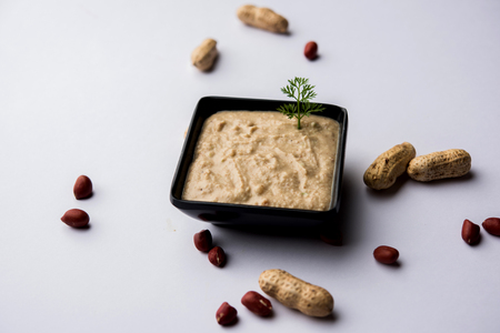 Healthy Peanut chutney made using Groundnut / Shengdana or mungfali. served in a small bowl with raw whole. Selective focusの写真素材