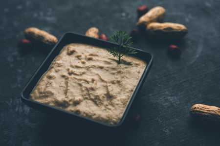Healthy Peanut chutney made using Groundnut / Shengdana or mungfali. served in a small bowl with raw whole. Selective focusの写真素材