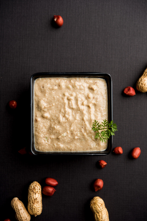 Healthy Peanut chutney made using Groundnut / Shengdana or mungfali. served in a small bowl with raw whole. Selective focusの写真素材