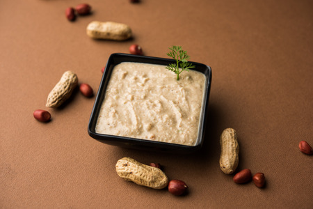 Healthy Peanut chutney made using Groundnut / Shengdana or mungfali. served in a small bowl with raw whole. Selective focusの写真素材