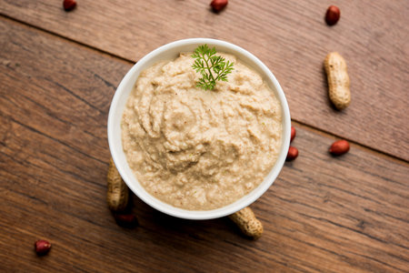 Healthy Peanut chutney made using Groundnut / Shengdana or mungfali. served in a small bowl with raw...