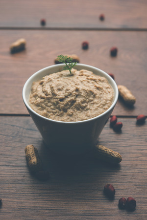 Healthy Peanut chutney made using Groundnut / Shengdana or mungfali. served in a small bowl with raw whole. Selective focusの写真素材