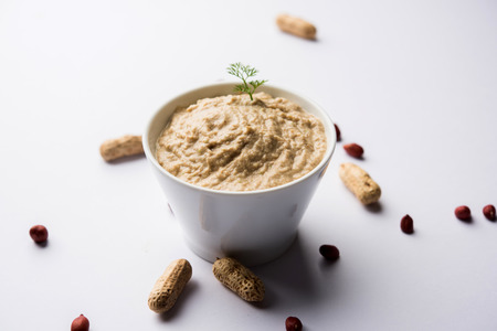 Healthy Peanut chutney made using Groundnut / Shengdana or mungfali. served in a small bowl with raw whole. Selective focusの写真素材