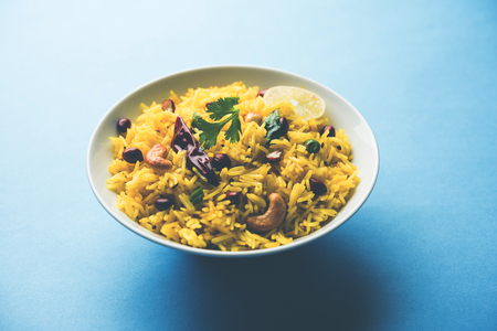 Lemon Rice is a South Indian turmeric rice or maharashtrian recipe called fodnicha bhat using leftover rice garnished with nuts curry leaves and lemon juice, selective focusの写真素材
