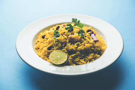 Lemon Rice is a South Indian turmeric rice or maharashtrian recipe called fodnicha bhat using leftover rice garnished with nuts curry leaves and lemon juice, selective focusの写真素材