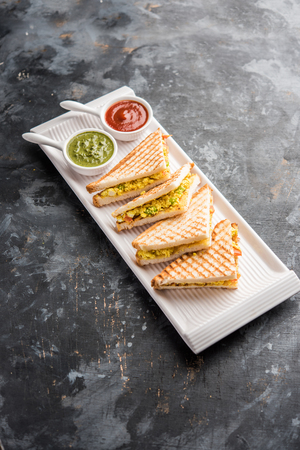 Paneer bhurji sandwich is a tasty paneer based dish made with cottage cheese.served with fresh tomato ketchup and green mint chutney. selective focusの写真素材