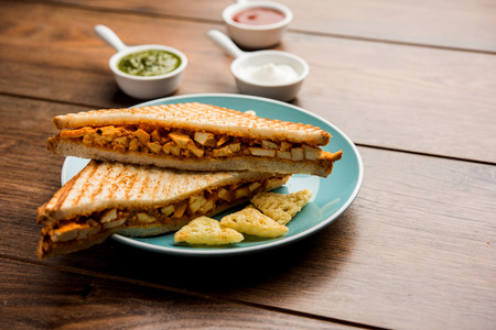 Paneer tikka Sandwich - is a popular Indian version of sandwich using cottage cheese curry with tomato ketchup, mint chutneyの写真素材