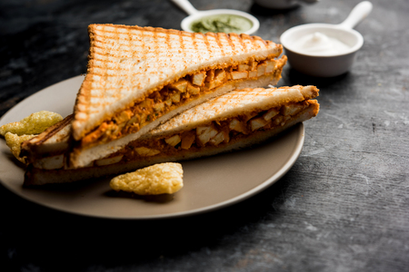 Paneer tikka Sandwich - is a popular Indian version of sandwich using cottage cheese curry with tomato ketchup, mint chutneyの写真素材