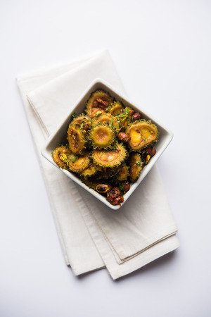 Cooked bitter Melon/gourd or Karela Sabzi served in a bowl. Scientific name of this healthy vegetable is Momordica charantia. selective focusの写真素材