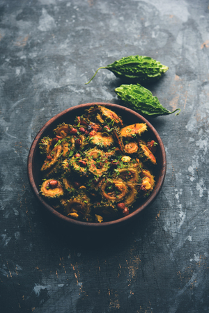 Cooked bitter Melon/gourd or Karela Sabzi served in a bowl. Scientific name of this healthy vegetable is Momordica charantia. selective focusの写真素材