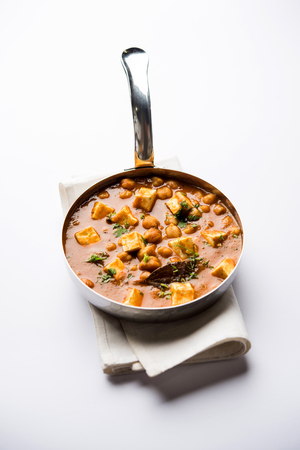Chole Paneer curry made using boiled chickpea with cottage cheese with spices. Popular North Indian recipe. served in a bowl or serving pan. Selective focusの写真素材