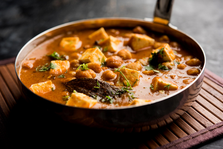 Chole Paneer curry made using boiled chickpea with cottage cheese with spices. Popular North Indian recipe. served in a bowl or serving pan. Selective focusの写真素材