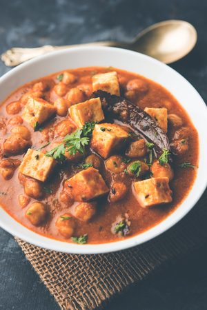 Chole Paneer curry made using boiled chickpea with cottage cheese with spices. Popular North Indian recipe. served in a bowl or serving pan. Selective focusの写真素材