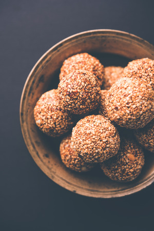 Tilgul Laddu or Til Gul balls for makar sankranti, it's a healthy food made using sesame, crushed peanuts and jaggery. served in a bowl. selective focus showing details.の写真素材