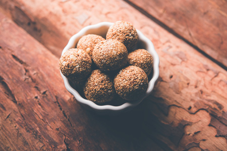 Tilgul Laddu or Til Gul balls for makar sankranti, it's a healthy food made using sesame, crushed peanuts and jaggery. served in a bowl. selective focus showing details.の写真素材