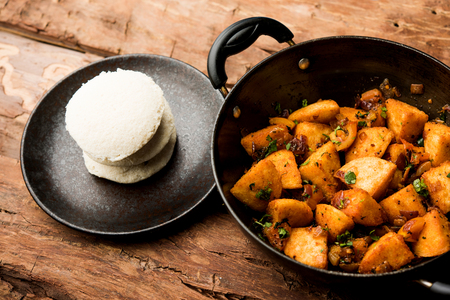 Masala fried Idlies or Idli fry - south indian Snack made using with leftover idly served with tomato ketchup. selective focusの写真素材