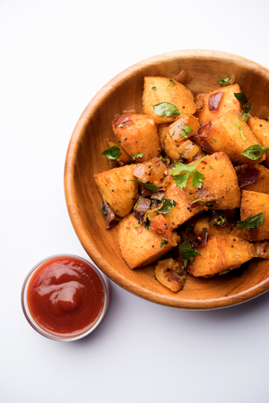 Masala fried Idlies or Idli fry - south indian Snack made using with leftover idly served with tomato ketchup. selective focusの写真素材
