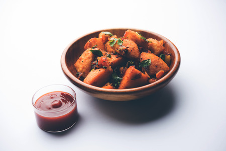 Masala fried Idlies or Idli fry - south indian Snack made using with leftover idly served with tomato ketchup. selective focusの写真素材