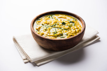 Dal Palak or Lentil spinach curry - popular Indian main course healthy recipe. served in a...