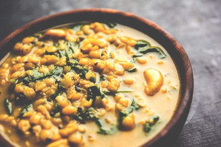 Dal Palak or Lentil spinach curry - popular Indian main course healthy recipe. served in a...