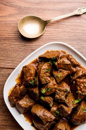 Mutton Liver fry or Kaleji masala, popular Non vegetarian recipe from India and Pakistan. served dry or with curry in a bowl, karahi or plateの写真素材