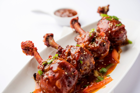 Szechuan Chicken which is a popular Indo-Chinese non vegetarian recipe. served in a plate with chilli sauce. selective focusの写真素材