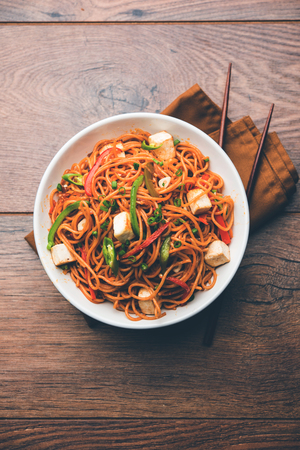 Schezwan hakka noodles with paneer or cottage cheese. Served in a bowl. selective focusの写真素材