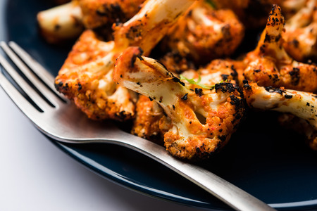 Tandoori Gobi / Roasted cauliflower Tikka is a dry dish made by roasting Cauliflowers in Oven/Tandoor. It's  popular starter food from India. served with ketchup. selective focusの写真素材