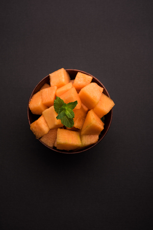 Cantaloupe / muskmelon / kharbuja cut into pieces, served in a bowl. selective focusの写真素材