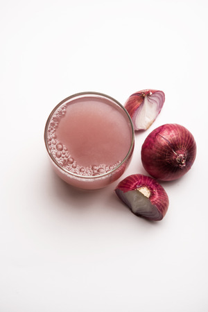 Medicinal Onion juice/syrup in a glass with raw onions. selective focusの写真素材