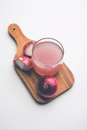 Medicinal Onion juice/syrup in a glass with raw onions. selective focusの写真素材