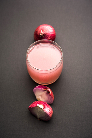 Medicinal Onion juice/syrup in a glass with raw onions. selective focusの写真素材