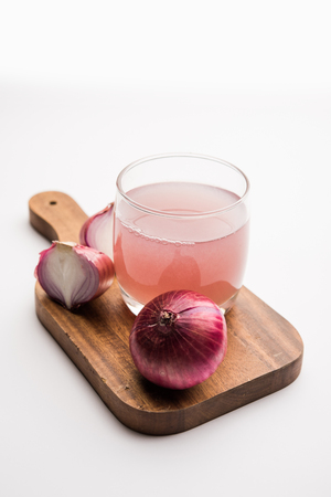 Medicinal Onion juice/syrup in a glass with raw onions. selective focusの写真素材