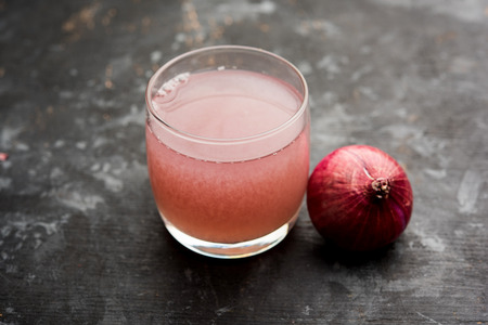 Medicinal Onion juice/syrup in a glass with raw onions. selective focusの写真素材