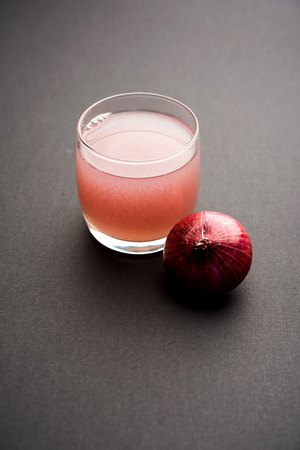 Medicinal Onion juice/syrup in a glass with raw onions. selective focusの写真素材